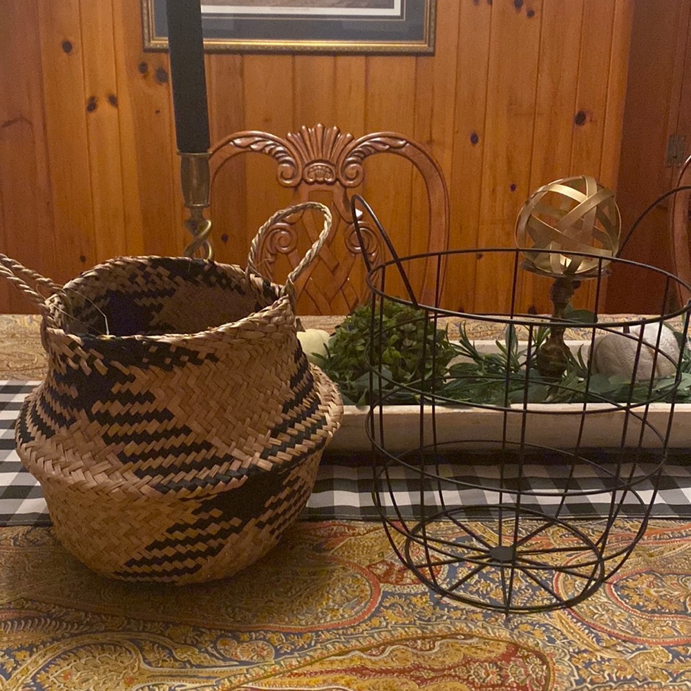 2 coordinating baskets. One is natural/black straw, the other is black metal.